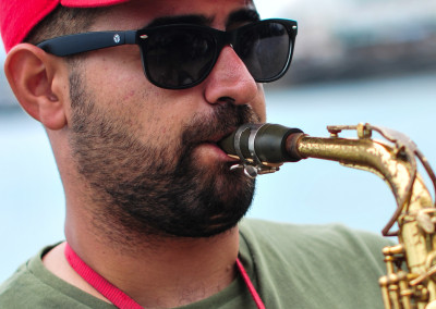 Saxophon Spieler Mann mit Vollbart und roter Baseball Kappe